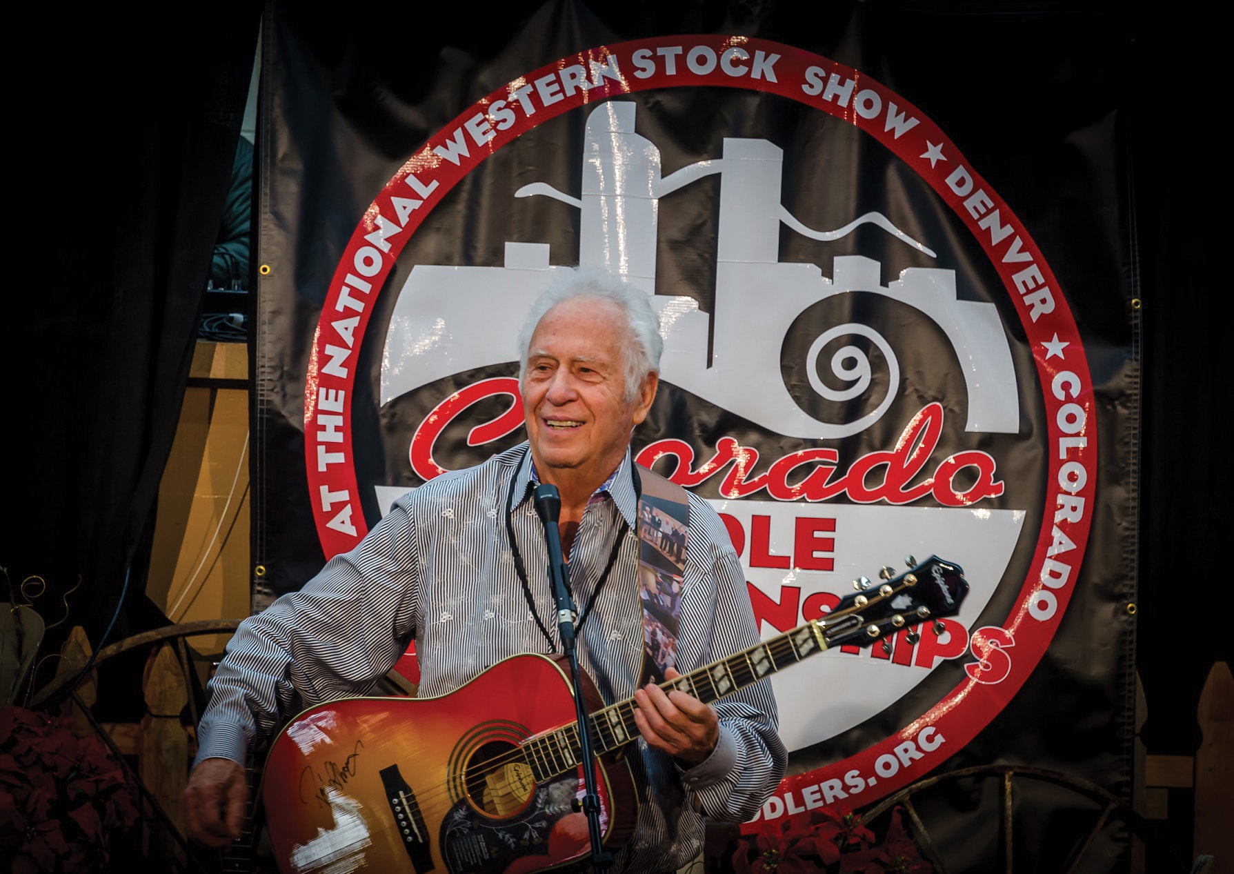 Jakek playing guitar at the Old Time Fiddlers at the National Western Stock Show