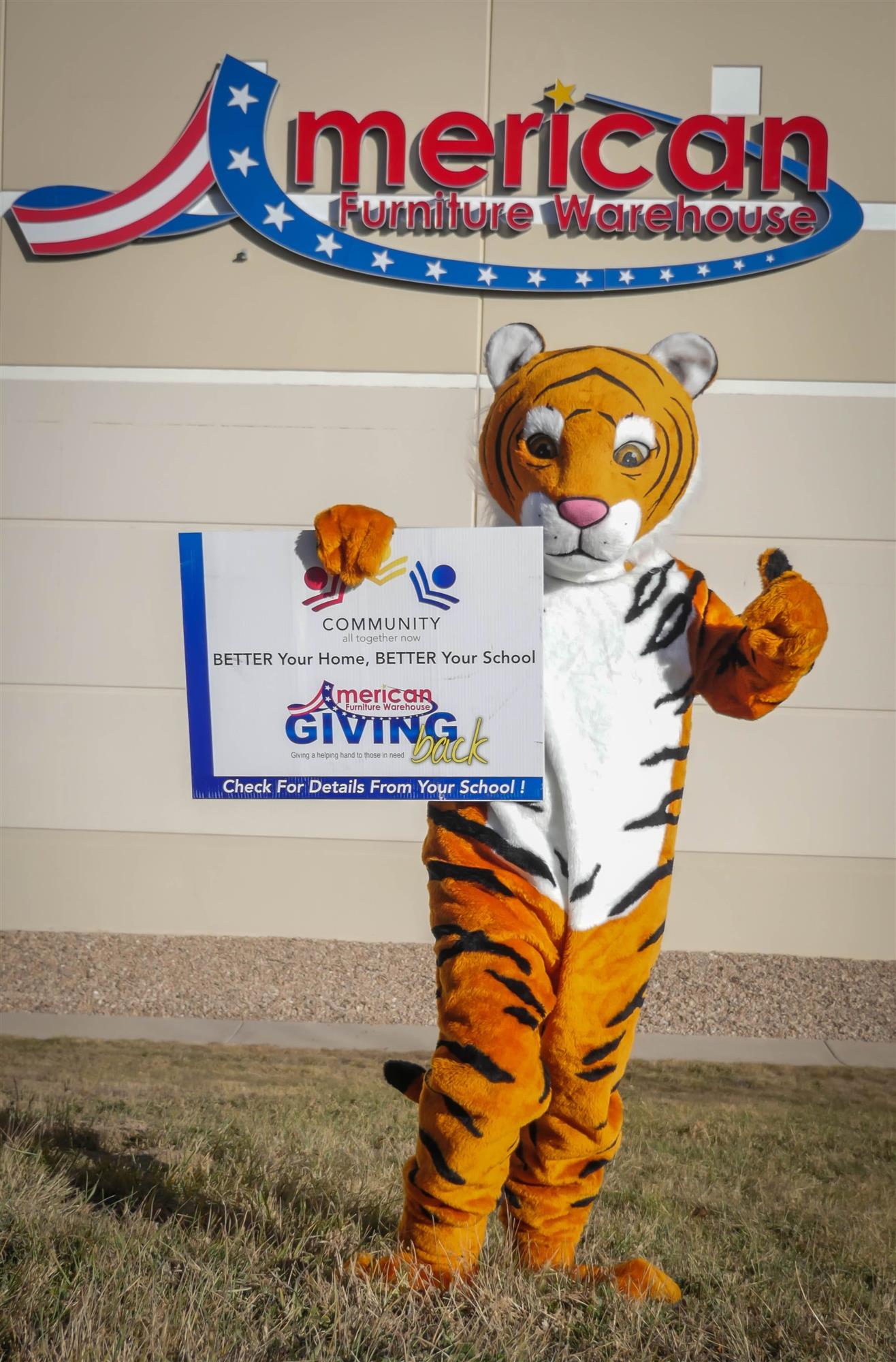 Tiger mascot wtih BETTER Your Home, BETTER Your School sign